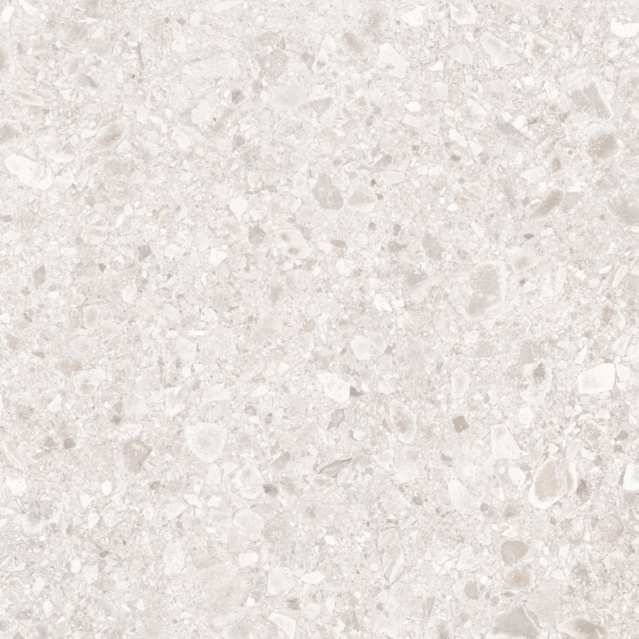 The Amalfi 32x32 Porcelain Tile features a light beige terrazzo look with small to medium stone and marble fragments in a polished finish, ideal for luxury interiors with its elegant speckled, textured stone-effect surface.