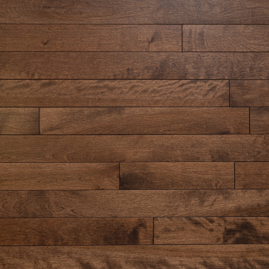 Lafayette 3 1/4" Birch Hardwood offers dark brown flooring with visible grain and subtle color variations, featuring long horizontal planks in a staggered layout for an elegant hardwood appearance.