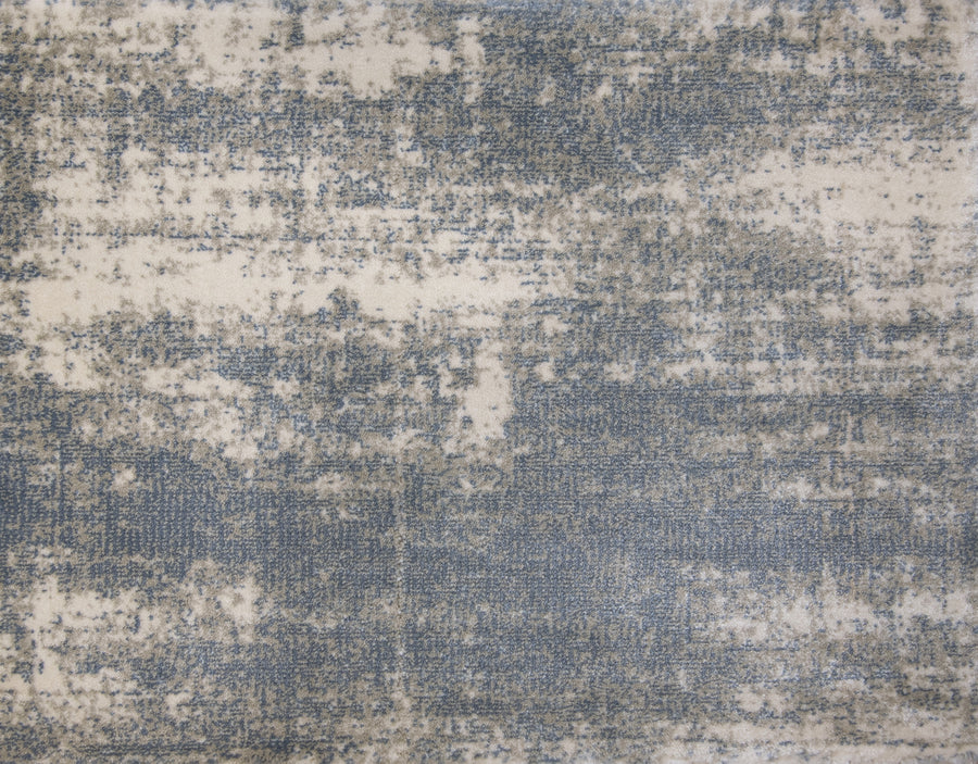 A close-up of the Landscape On Trend Carpet, showcasing its abstract pattern in blended blue, gray, and off-white tones for a stylish distressed look.