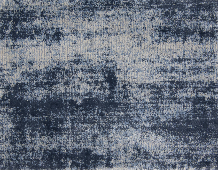 A close-up of the Landscape On Trend Carpet shows its textured, custom finish with an abstract navy blue and beige pattern for a distressed, weathered look.
