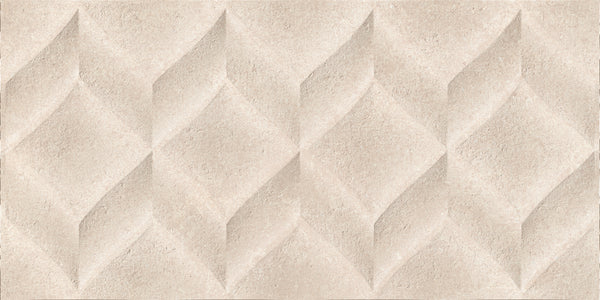 The Omni 12x24 Rectified Glazed Ceramic Tile features a textured beige finish with a repeating raised diamond geometric pattern, creating an elegant three-dimensional effect and subtle shadows.