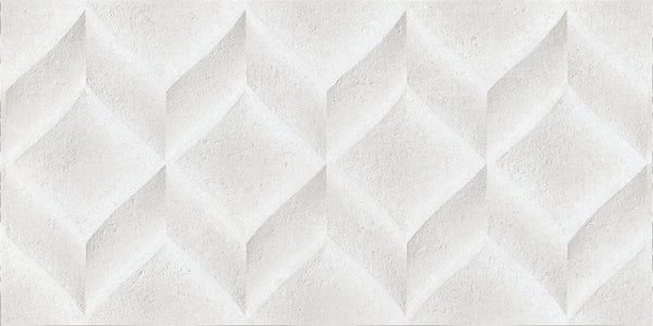 The Omni 12x24 Rectified Glazed Ceramic Tile features a textured white surface with geometric diamond patterns, offering a three-dimensional sculpted effect and subtle shadows for striking relief in any space.
