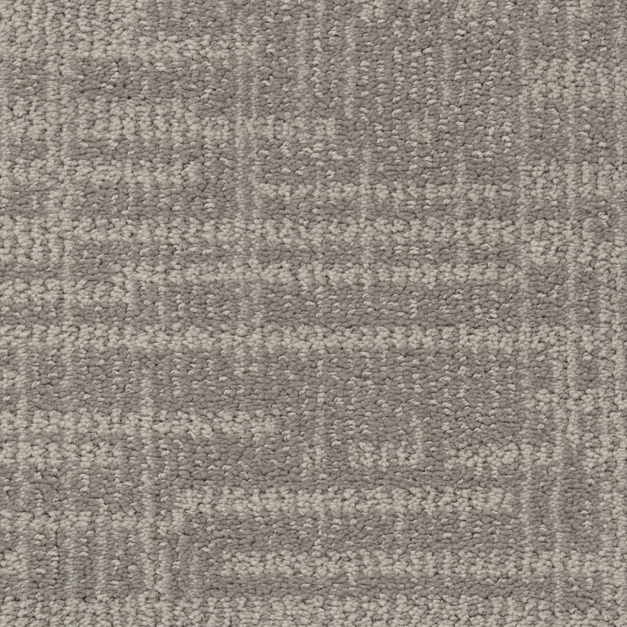 Close-up of Lineage Pet Friendly Carpet in grey, made with EnVisionSD yarn and featuring a subtle geometric grid pattern created by varying shades and textured loops for a modern look.