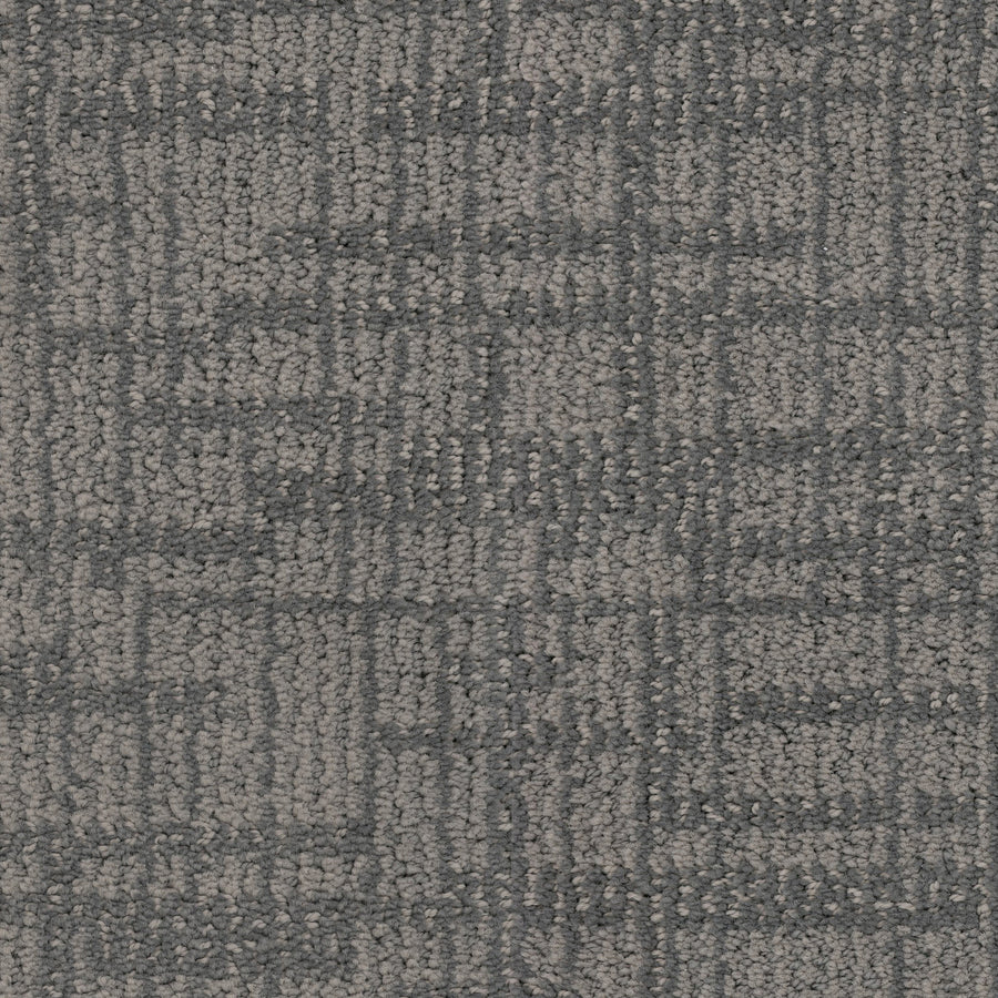 Close-up of Lineage Pet Friendly Carpet in textured gray with a subtle checkered pattern from intersecting dark and light lines. Crafted with EnVisionSD yarn, its solution dyed surface is soft, durable, and ideal for modern flooring.