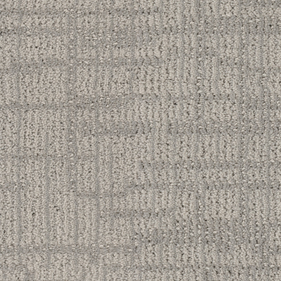 Close-up of Lineage Pet Friendly Carpet showcases a geometric pattern in light gray and beige. Made with EnVisionSD yarn, its soft looped fibers create a subtle, solution-dyed grid-like design that's both stylish and durable.