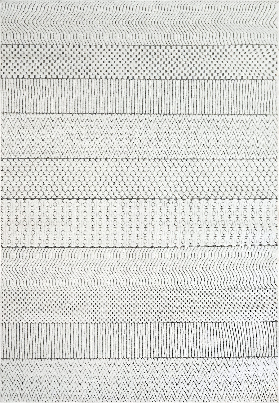 The Lotus 8140 Area Rug features horizontal rows of black and white geometric patterns—zigzags, dots, diamonds, and X shapes—for a modern look that adds textured style to any room.