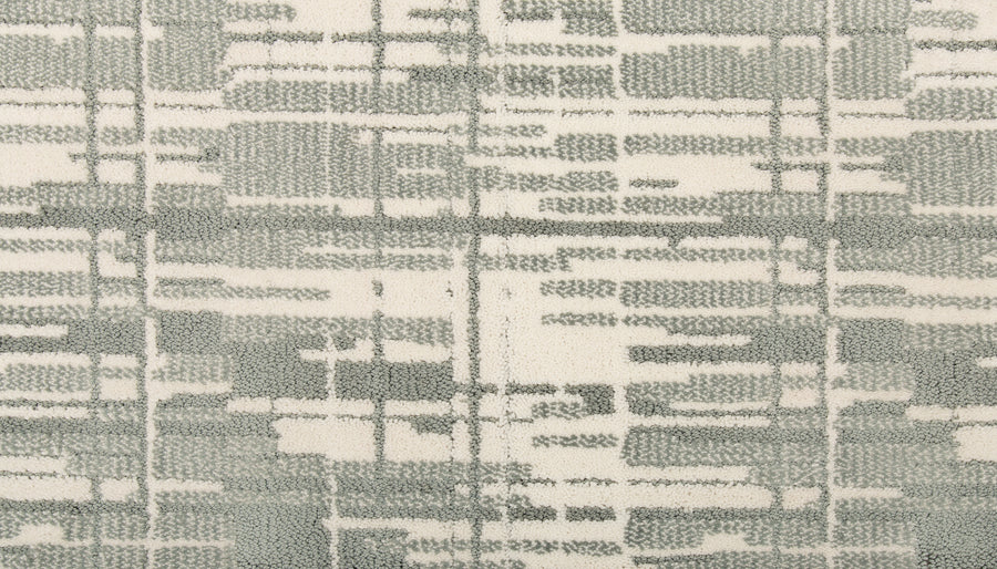 The Tartan Veil On Trend Carpet features intersecting lines and rectangles in muted grays and off-white, creating a modern, textured look ideal for elegant flooring with a woven fabric or city grid effect.