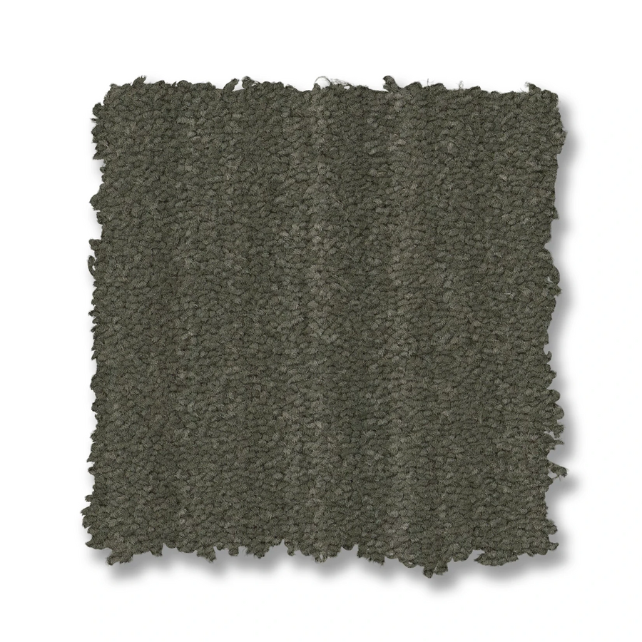 The Magnifique On Trend Carpet features a square swatch of dark gray, textured carpet with slightly rough edges, offering timeless beauty and stylish texture to any space.