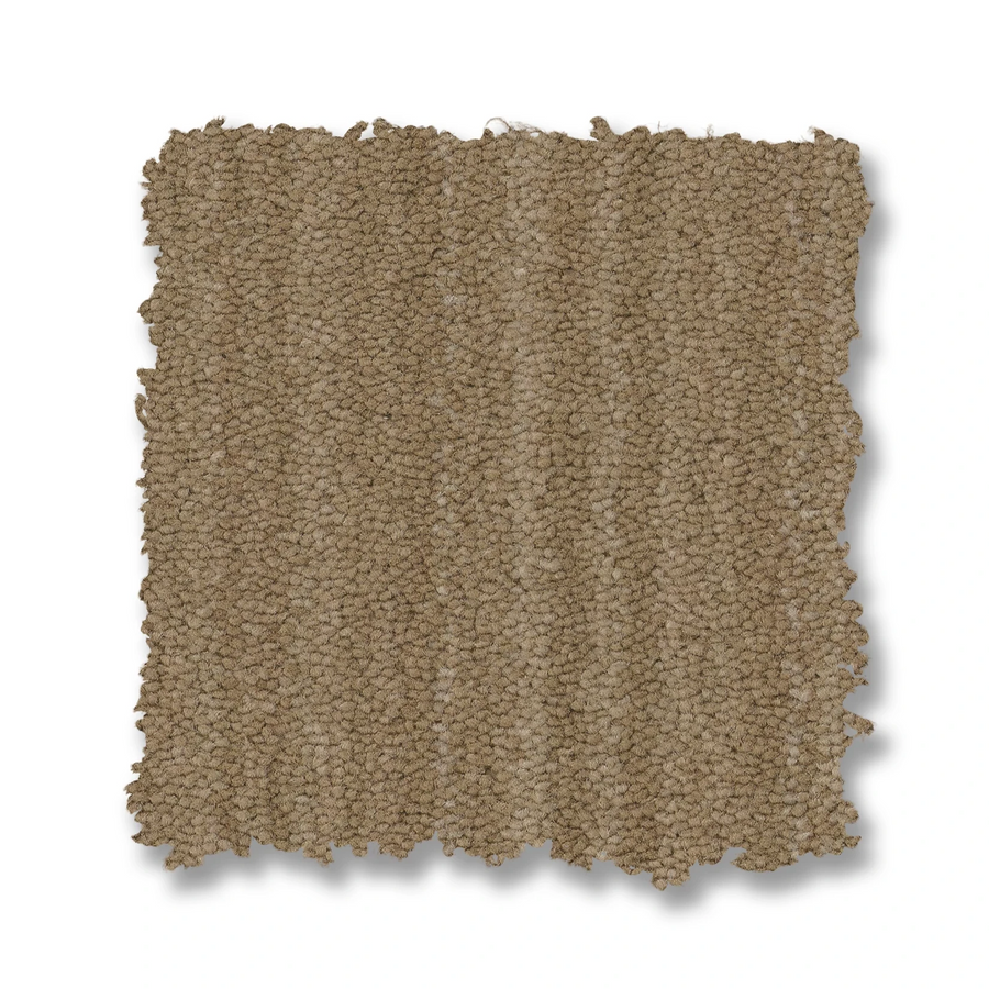 A square swatch of Magnifique On Trend Carpet in tan features a looped, textured woven look and timeless beauty, displayed against a white background. The swatch’s edges are slightly irregular and rough.