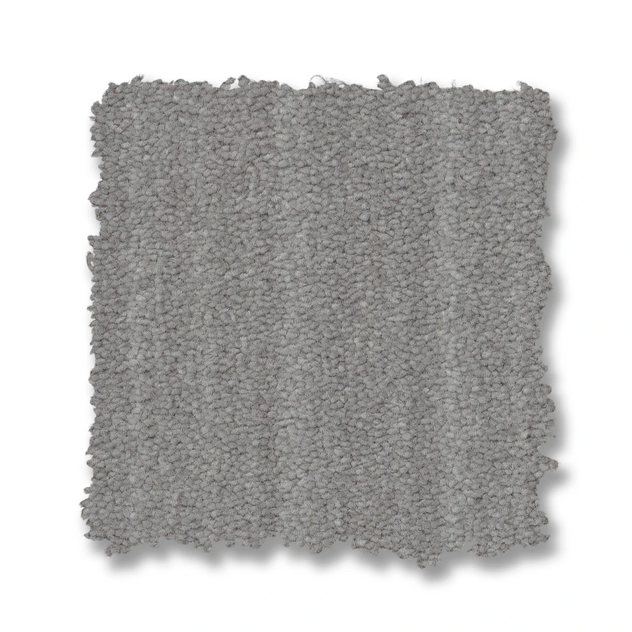 A square swatch of Magnifique On Trend Carpet in light gray, featuring a textured loop design and slightly uneven edges, is shown on a white background, highlighting its timeless beauty and inviting texture for any space.