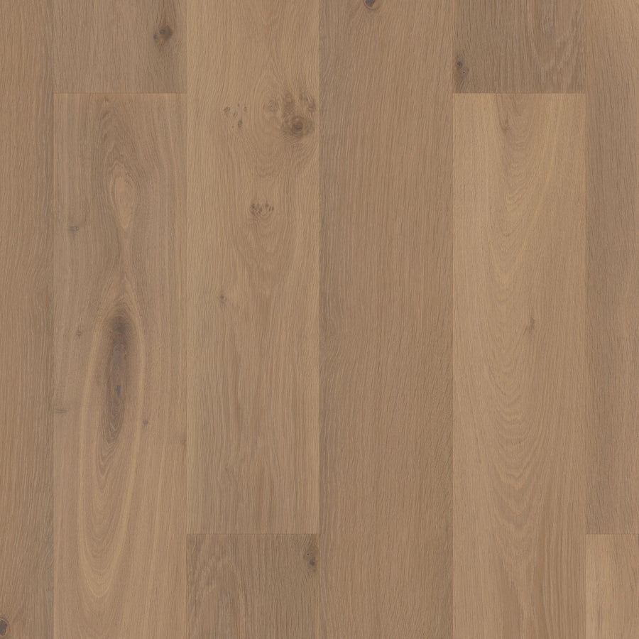 A close-up of Manchester 7 1/2" White Oak Hardwood planks in light brown, showcasing natural grain patterns and knots, arranged vertically for a classic, timeless appearance.
