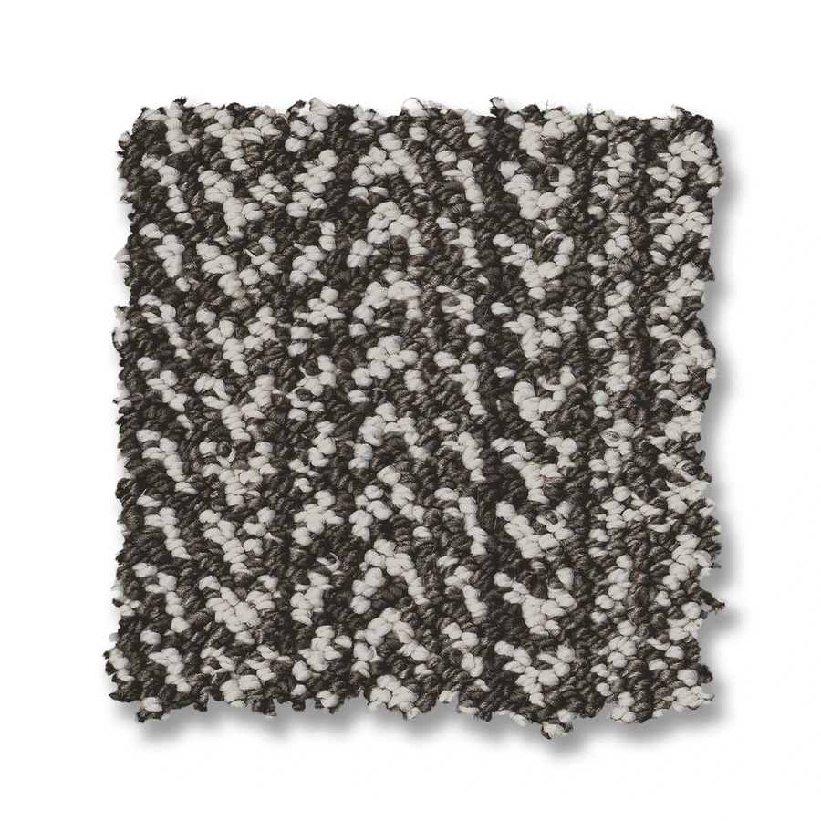 The Marquet On Trend Carpet swatch showcases a contemporary zigzag pattern in dark brown and off-white, blending looped and cut pile fibers, displayed against a white background.