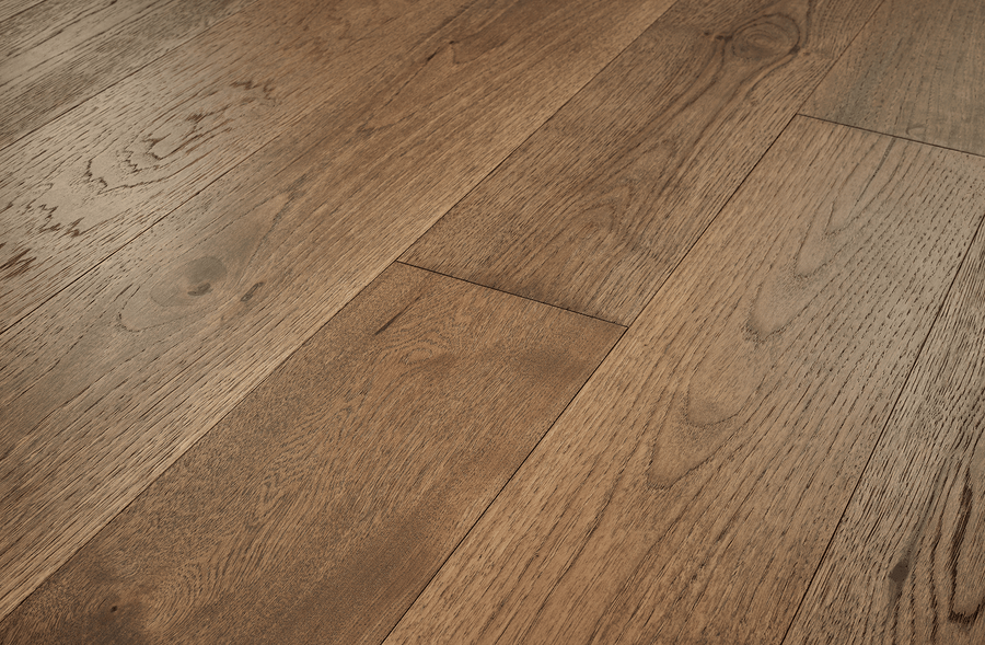 Close-up of Fairmount Hickory 7 1/2" Hardwood flooring, highlighting wide planks with a natural finish that showcases unique wood grain patterns and subtle color and texture variations.