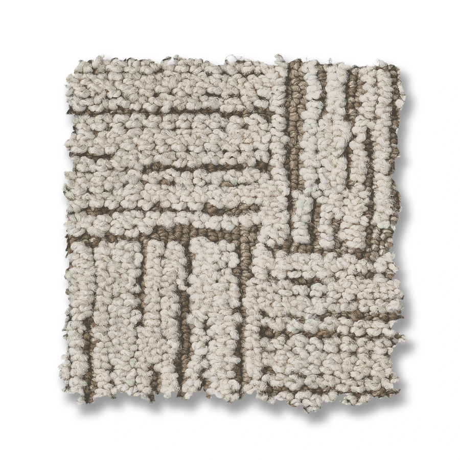A square sample of Moderne On Trend Carpet in neutral tones, showcasing a basket weave pattern with beige and brown vertical and horizontal tufted designs on a white background.