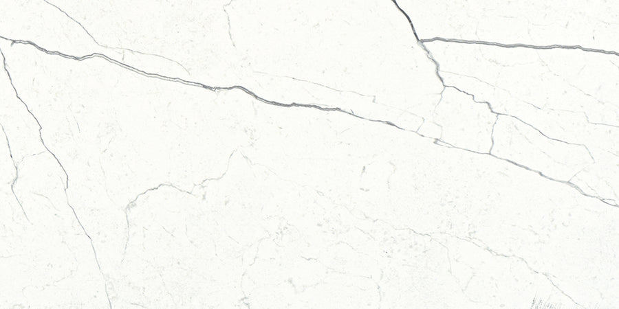 The Monaco 4x12 Porcelain Tile features a white marble look with subtle gray veining and cracks, offering a natural, elegant stone texture for a luxurious finish.