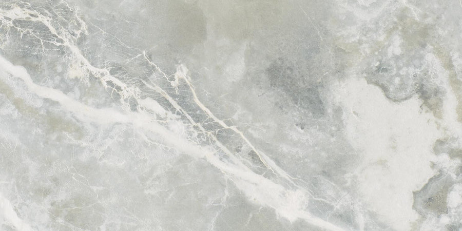 The Monaco 4x12 Porcelain Tile showcases a light gray and white marble look with subtle veining and cloudy patterns, plus streaks in varying gray and off-white shades, delivering a luxurious finish.