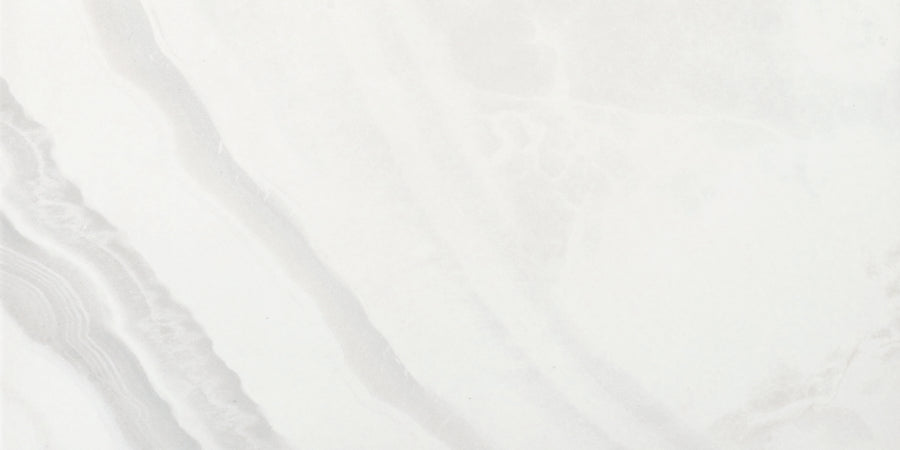 The Monte Carlo 24x48 Polished Porcelain Tile features a subtle white marble look with faint gray veining and soft, diagonal wavy patterns—ideal for creating elegant, refined flooring in any home.