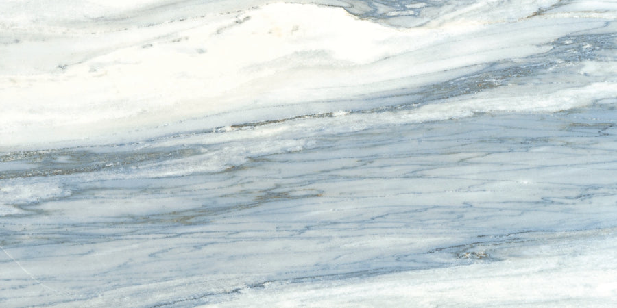 The Monte Carlo 24x48 Polished Porcelain Tile features a light gray and white marble look with soft blue-gray veining, offering a smooth, elegant finish ideal for luxury designs and stylish home flooring.