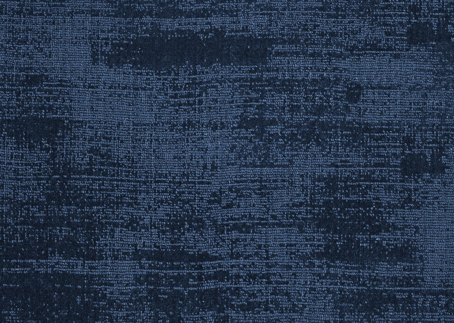 The Prague On Trend Carpet features dark blue textured fabric with mottled patterns and subtle lines, offering a luxurious feel and modern color palette.