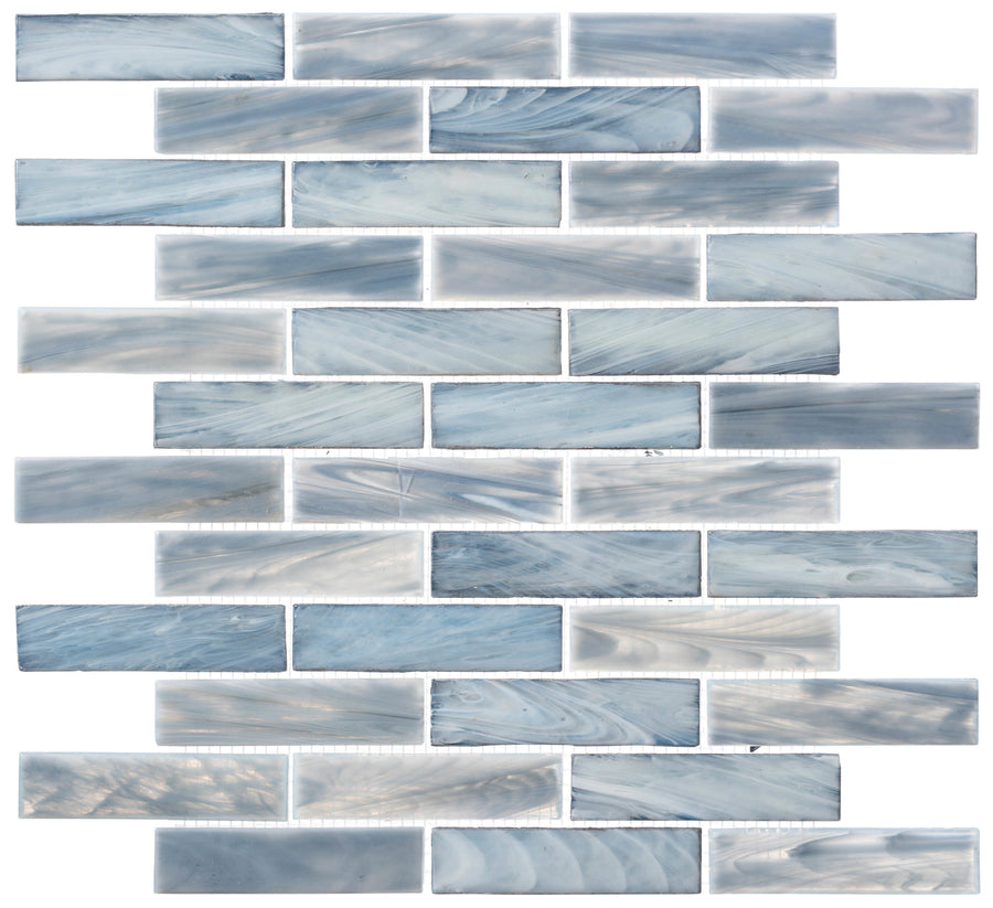 The New England Brick Glass Tile features rectangular blue and white handmade mosaic tiles in a staggered brick pattern, each with a unique marble-like swirl and glossy finish—ideal for kitchen backsplashes or bathroom showers.