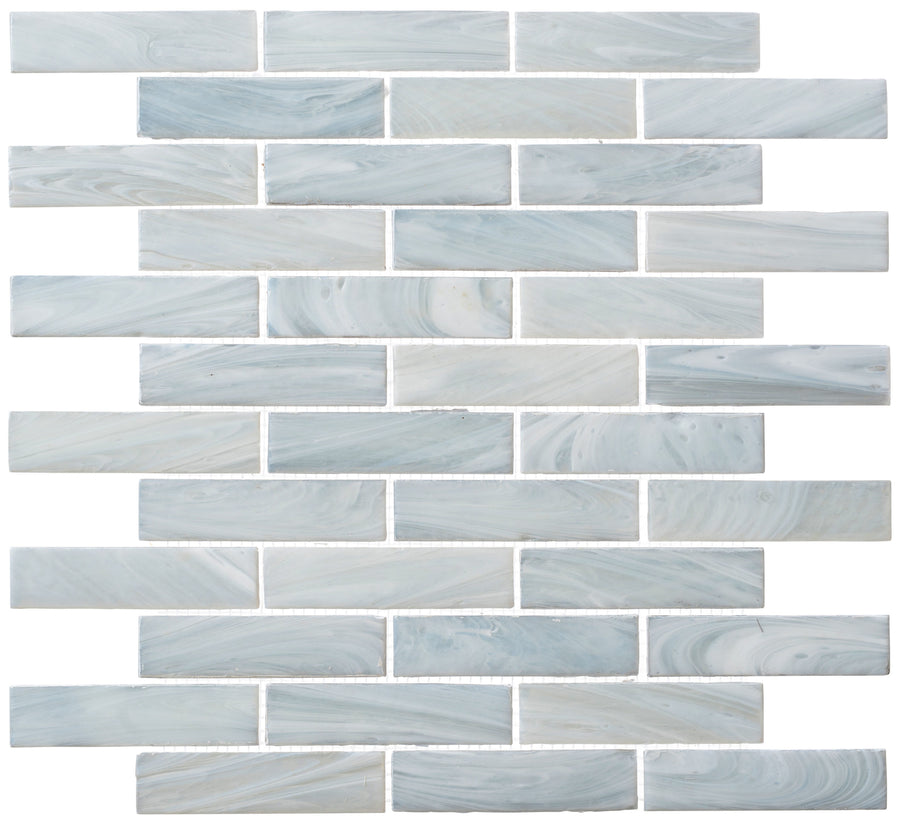 New England Brick Glass Tile features a glossy, marbled light blue and white finish in a staggered brick layout with white grout—ideal for bathroom showers or kitchen backsplashes.