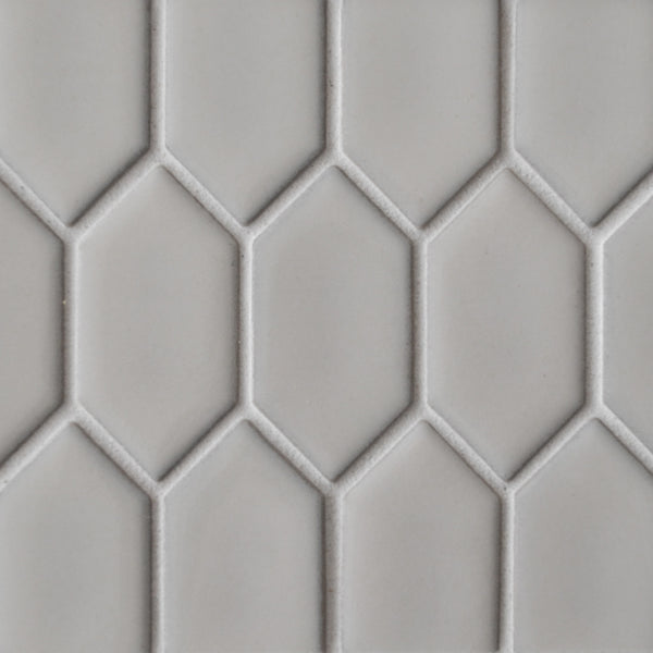 Close-up of a New Form Picket Mosaic Tile shower wall, showcasing a light gray geometric honeycomb pattern made from elongated hexagons outlined in a slightly darker shade.