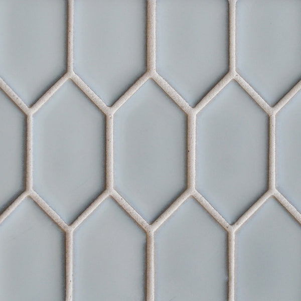 The New Form Picket Mosaic Tile features a light gray geometric design of elongated hexagons with white grout, creating a chic honeycomb look—ideal for modern shower walls or backsplashes.