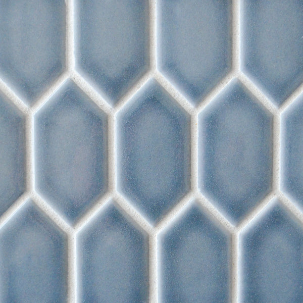 Close-up of New Form Picket Mosaic Tile in blue, showcasing a repeating hexagon pattern with white grout—offering a modern, geometric look perfect for stylish backsplashes or shower walls.
