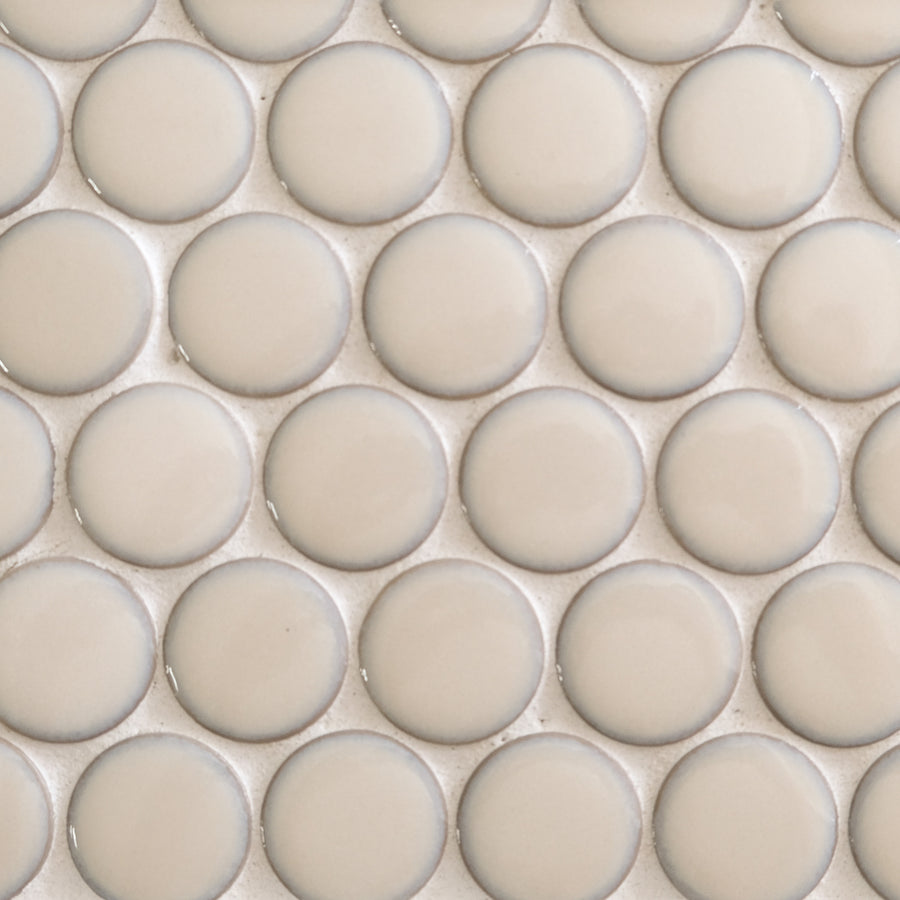 Close-up of New Form Penny Round Mosaic Tile: beige, glossy, round tiles set in a grid with light grout—an elegant pick for shower walls or backsplashes.
