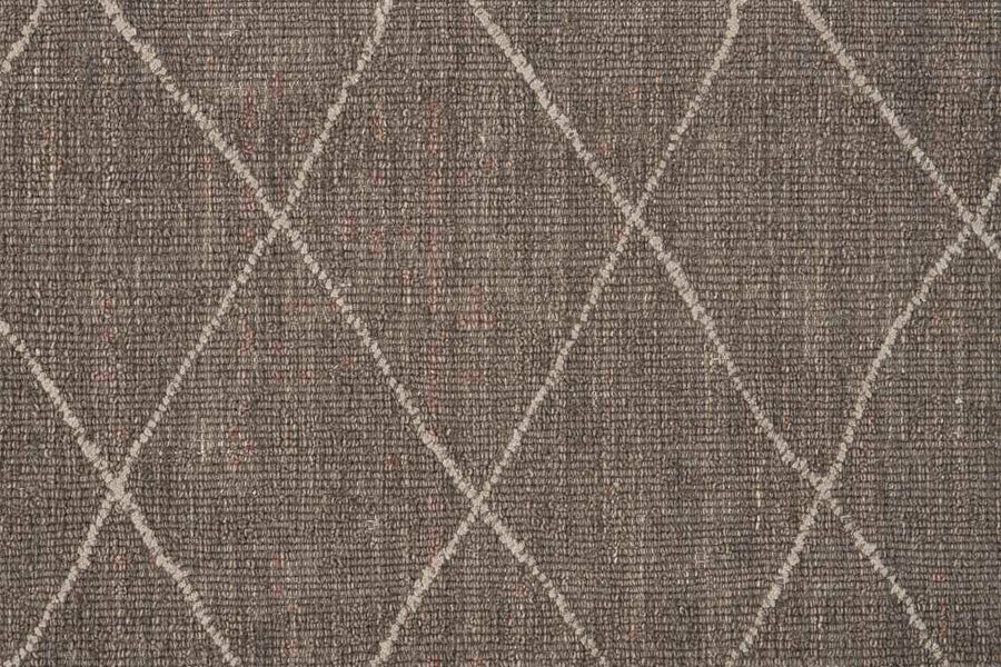 Close-up of Old World Trellis On Trend Wool Carpet, featuring textured brown distressed pile with a diamond crisscross pattern in lighter lines. Varied fibers add woven detail, echoing the look of a vintage wool trellis rug.