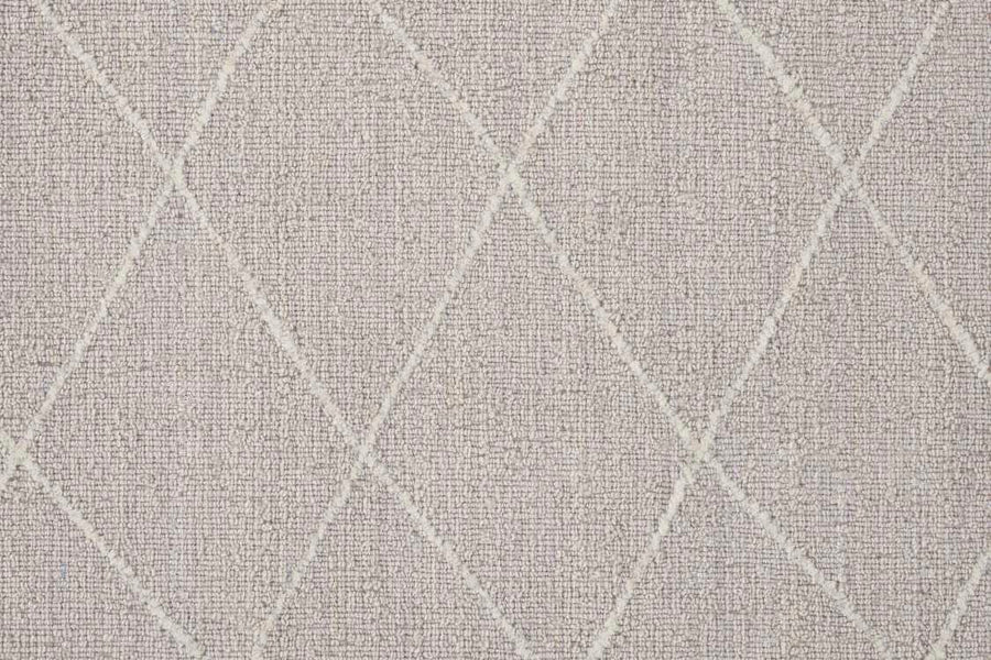 The Old World Trellis On Trend Wool Carpet features a beige base with a subtle texture and a diagonal white diamond pattern, offering classic vintage style inspired by traditional wool trellis rugs.