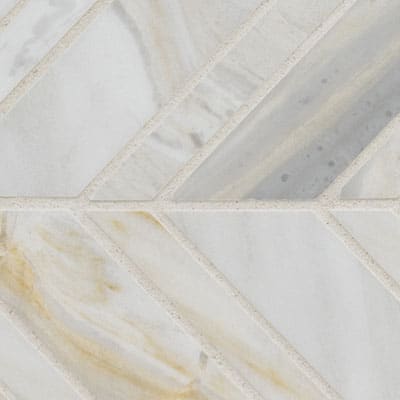 The Olympia Sandalwood Chevron Marble Mosaic features a geometric tile pattern with diagonal lines, light gray and white marble texture, and subtle beige and brown veining for an elegant natural marble look.