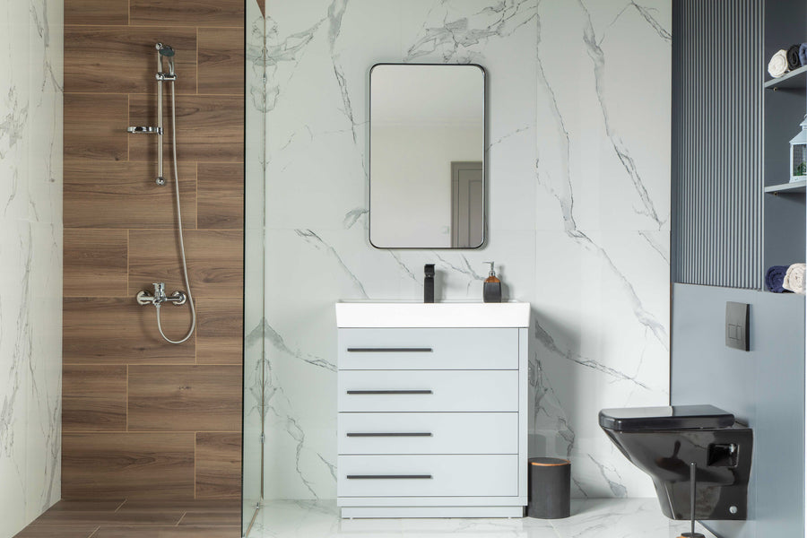 Modern bathroom with marble-patterned walls, a wood-paneled shower, Adora 32" Vanity with porcelain top and drawers, mirror, black toilet, towel shelving, and contemporary fixtures.