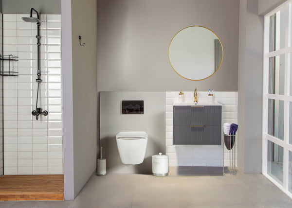 Modern bathroom with a walk-in shower on the left, wall-mounted toilet in the center, and a Sorrento 24