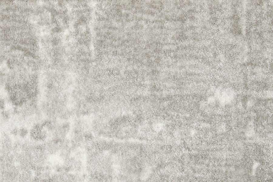 A close-up of the Oxford Street II On Trend Carpet reveals its soft, light gray, wall-to-wall surface with a slightly uneven texture and subtle shading variations.