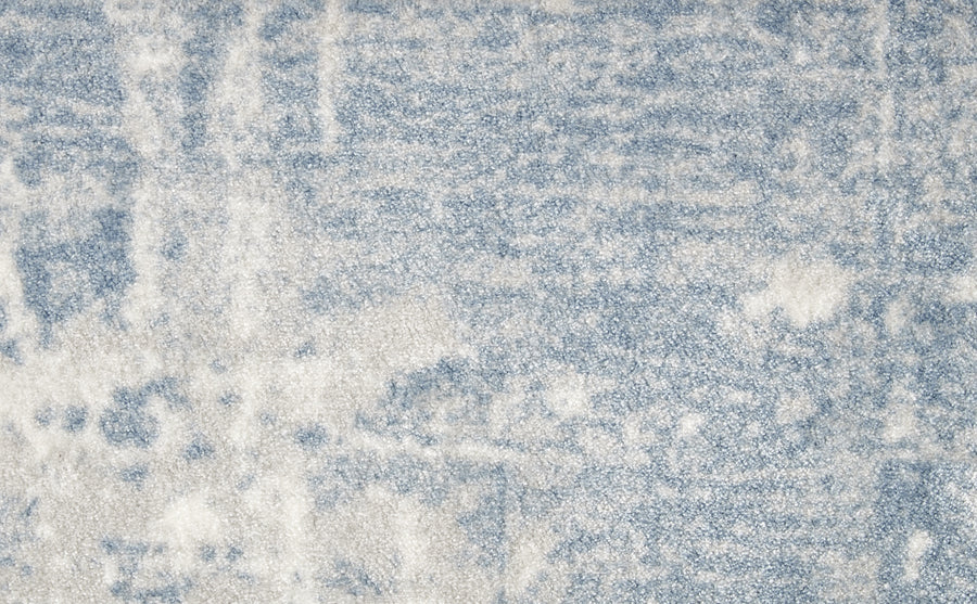 A close-up of the Oxford Street II On Trend Carpet highlights its soft, textured surface in light blue and white, featuring an abstract watercolor-inspired pattern.