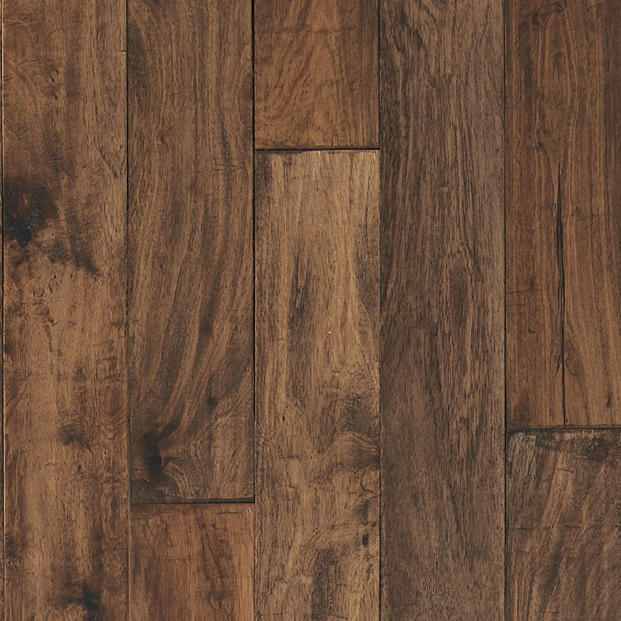 Close-up view of Palisade 5" White Teak Hardwood flooring shows warm brown tones, natural grain, and visible texture variations. The staggered floorboards add rustic charm—ideal for a modern farmhouse style.
