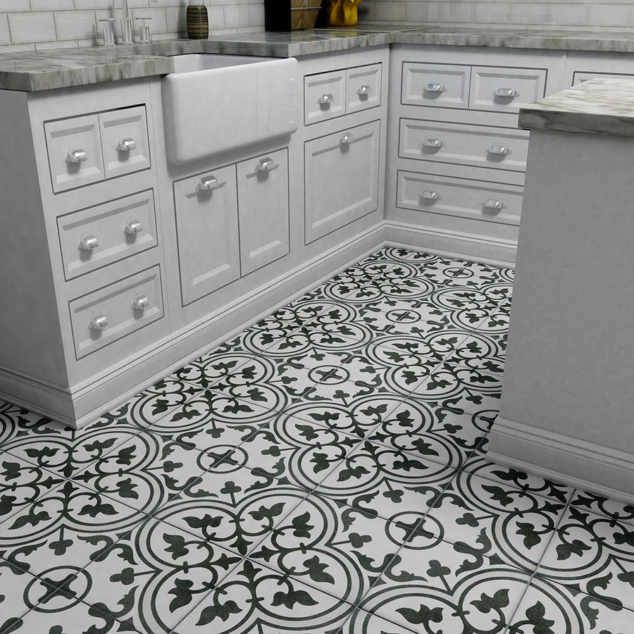 A kitchen corner with white cabinets, marble countertops, a farmhouse sink, and Arte 9 3/4 x 9 3/4 Patterned Tile on the floor and walls featuring bold black-and-white floral geometric circular designs.