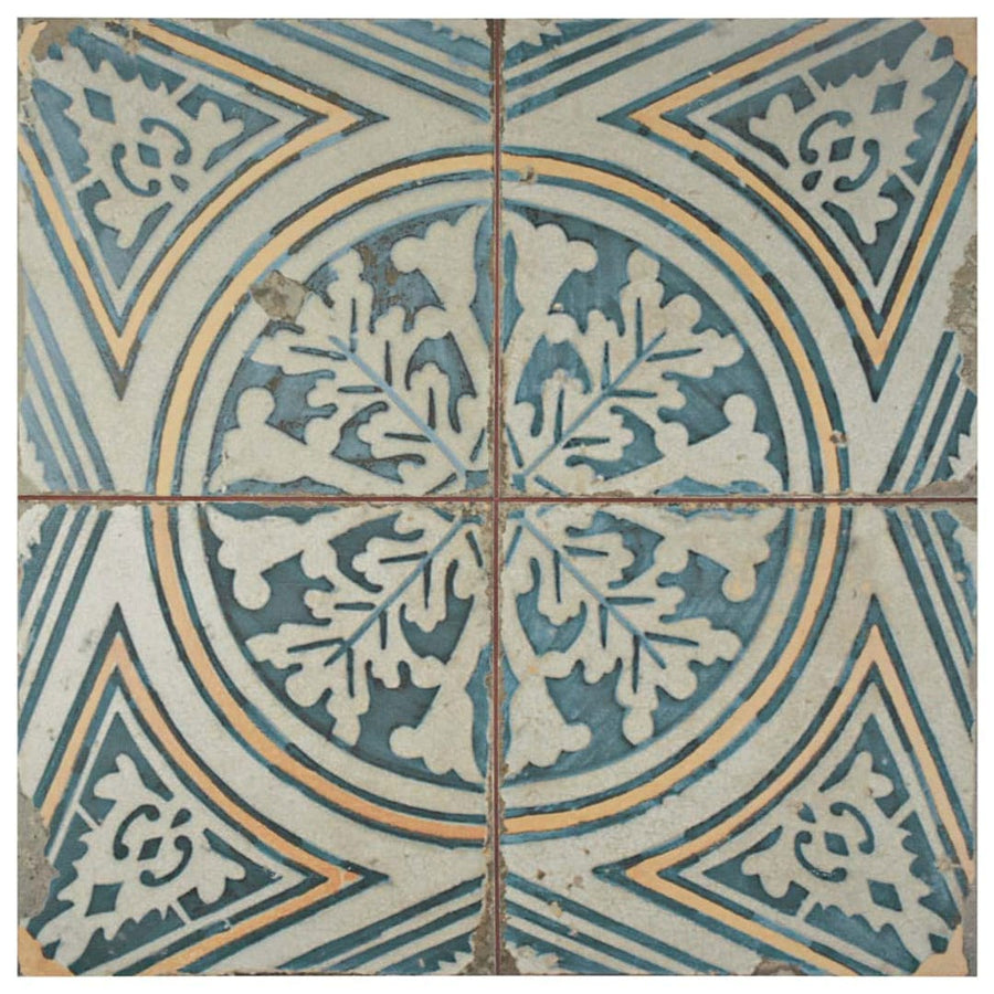 The Kings 17 3/4 x17 3/4 Patterned Tile features blue and white ceramic tiles with a central leaf motif, circular lines, and geometric borders. The encaustic-inspired design shows subtle wear for a vintage look.