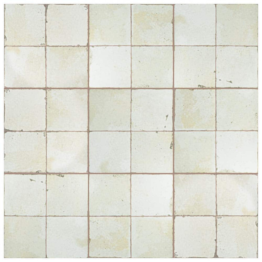 The Kings Manhattan 17 3/4 x17 3/4 Patterned Tile features a square off-white ceramic design with light brown grout lines, subtle wear, and vintage industrial details for a timeless, well-loved appearance on floors and walls.