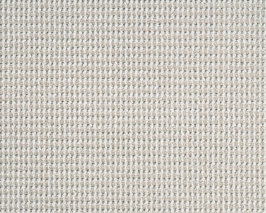Close-up of Bandala Jazzed Berber Carpet in beige, showcasing its textured waffle weave pattern of raised squares and a soft, uniform look. Made with durable Envision 66 fiber for lasting performance.