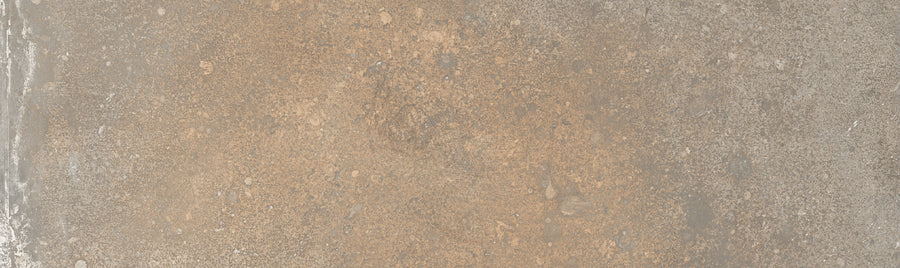 The Empire 2x10 Brick Porcelain Tile features a textured surface with light brown and gray tones, plus subtle spots and patches, delivering a rustic, weathered stone look.