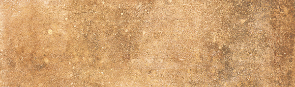 A close-up of Empire 2x10 Brick Porcelain Tile shows a textured brown surface with tan, gold, and brown tones and natural patterns, creating a weathered stone look ideal for rustic tile settings.