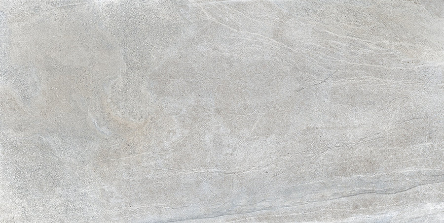 The Santorini 12x24 Porcelain Tile features a light gray stone-effect surface with subtle swirls and fine lines, offering a neutral, minimalist look reminiscent of natural concrete or marble with elegant texture.