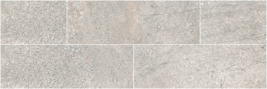 Five Santorini 4x12 Porcelain Tiles in light gray, with a stone look and subtle veining, are arranged in two rows. Their textured, neutral finish evokes natural elegance and the tactile beauty of real stone surfaces.