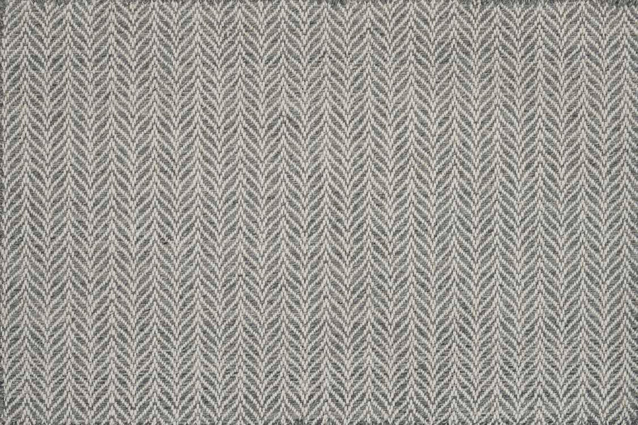 The Island Wave On Trend Carpet is a gray and white flatweave rug with a repeating chevron pattern for a textured, geometric look.