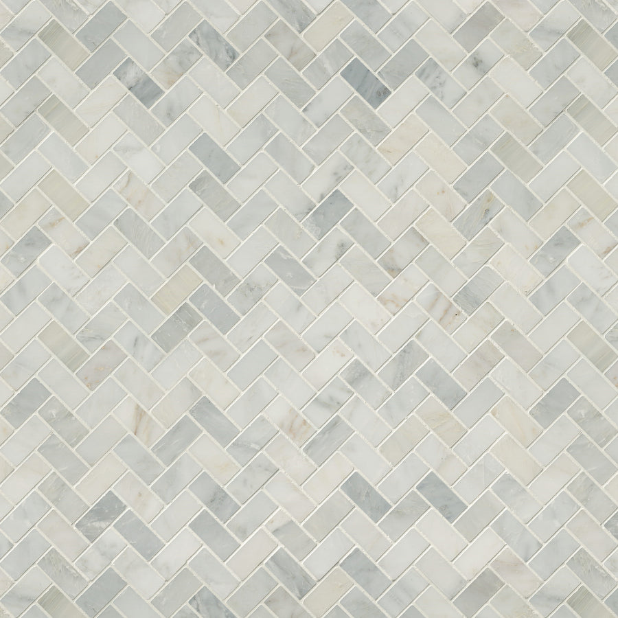 The Arabescata Carrara Select 1x2 Herringbone Marble features small, light gray and white tiles with subtle veining in a herringbone pattern, creating an elegant and textured natural stone mosaic surface.