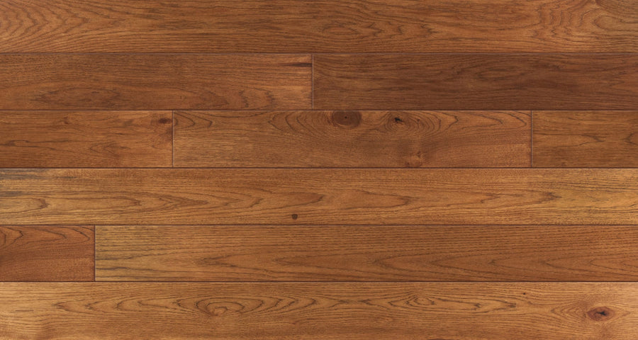 Close-up of Saloon 7 1/2" Hickory & Maple Hardwood flooring featuring medium brown, character grade maple planks with visible grain and hand-honed texture, arranged horizontally for a warm, polished look.