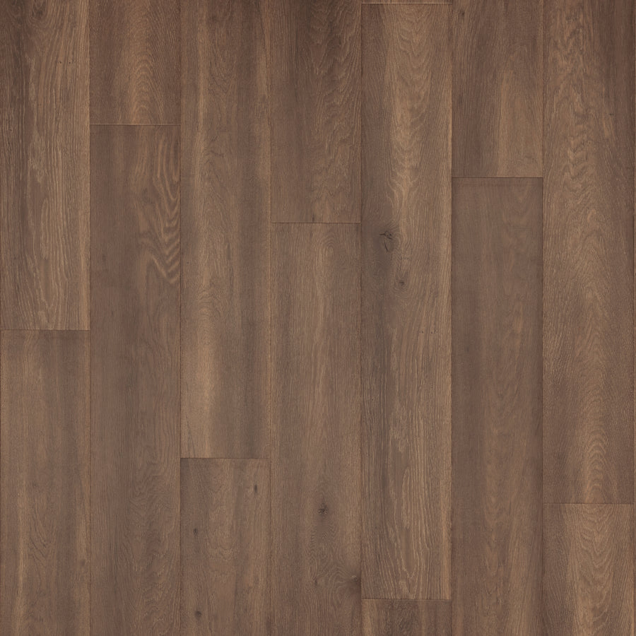 Miramar Cliffs 8.34" Waterproof Laminate features wide medium brown planks with a natural grain pattern and matte finish in a staggered layout, creating a smooth, even surface that highlights the wood’s varied shades and textures—ideal for luxury homes.