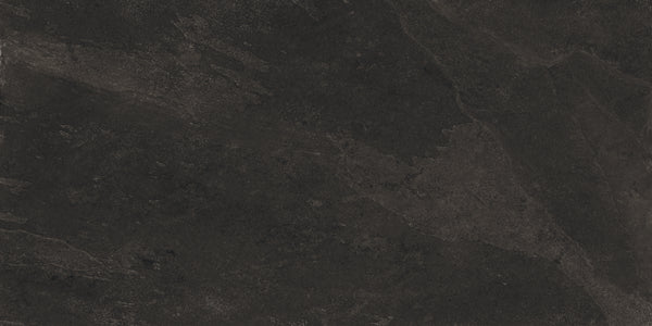 Shyft 24x48 Rectified Porcelain Tile features a dark, textured surface with subtle black and gray variations, natural patterns, and faint streaks that mimic Brazilian slate for a rugged, slate-like look.